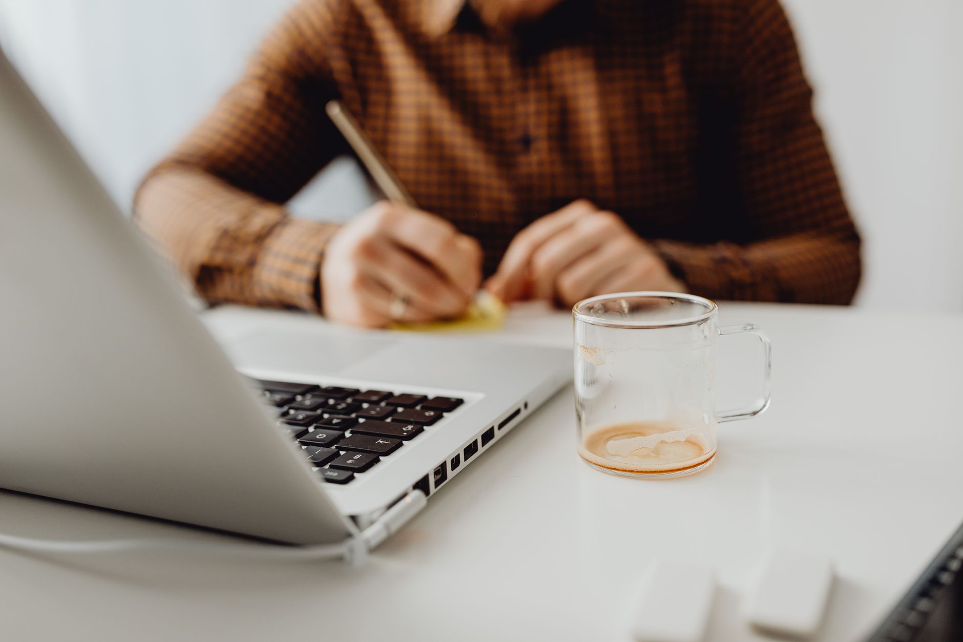 Freelancer organizing tasks by client in a productivity app on their laptop