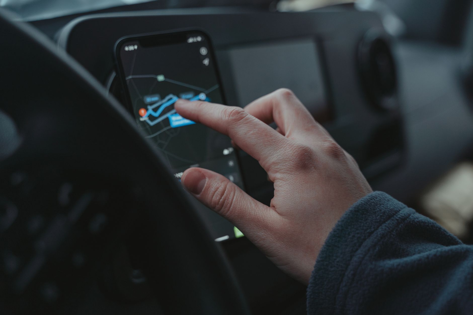 Plumber using a mobile app in his van to manage tasks