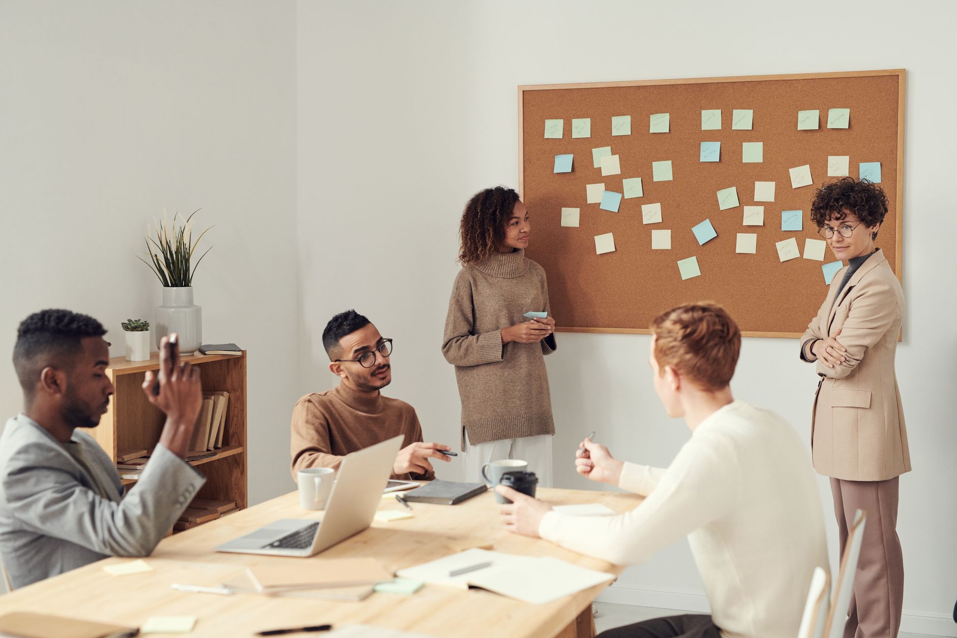 Small team reviewing critical tasks in a meeting using a productivity app