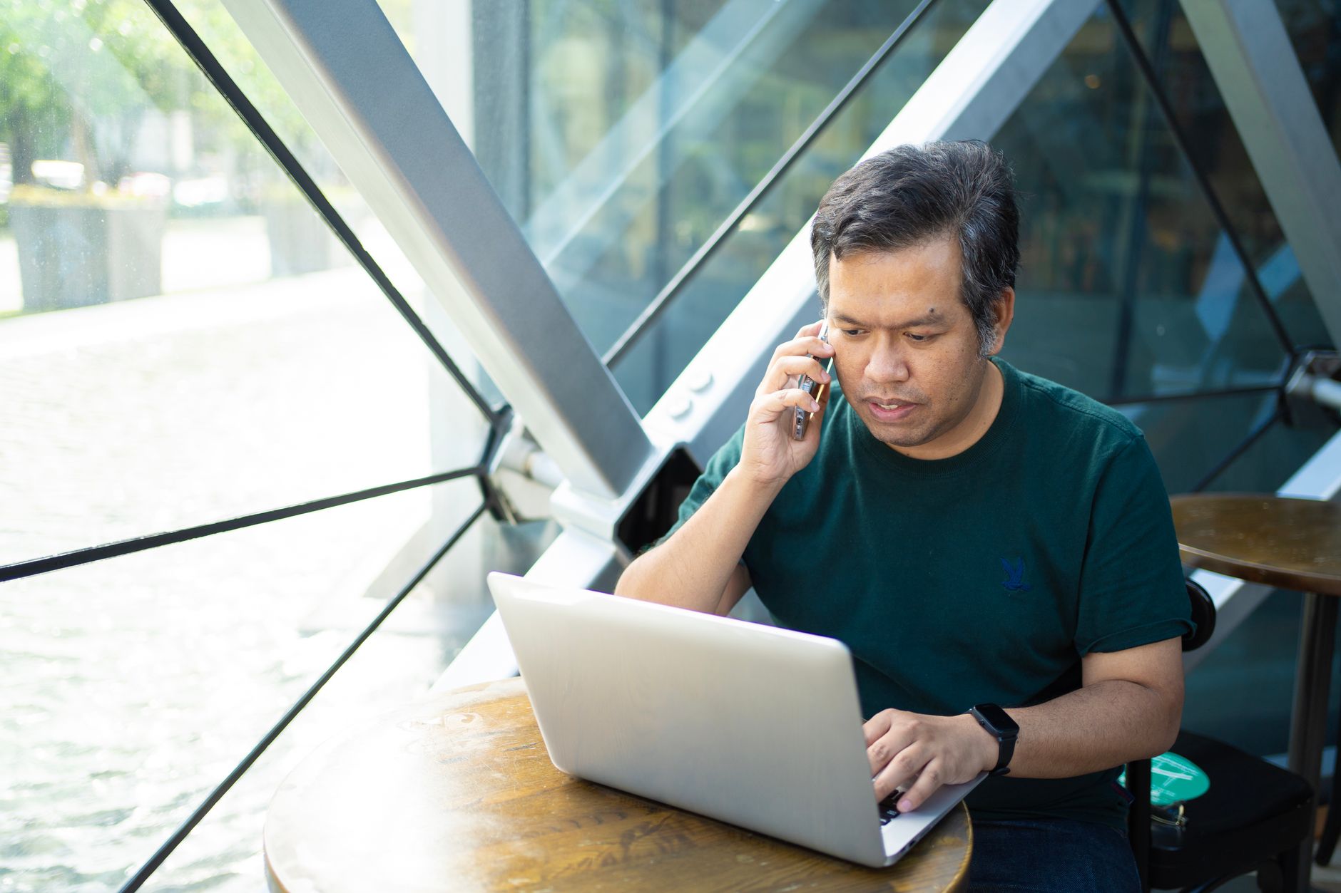 Freelancer working on laptop with multiple clients