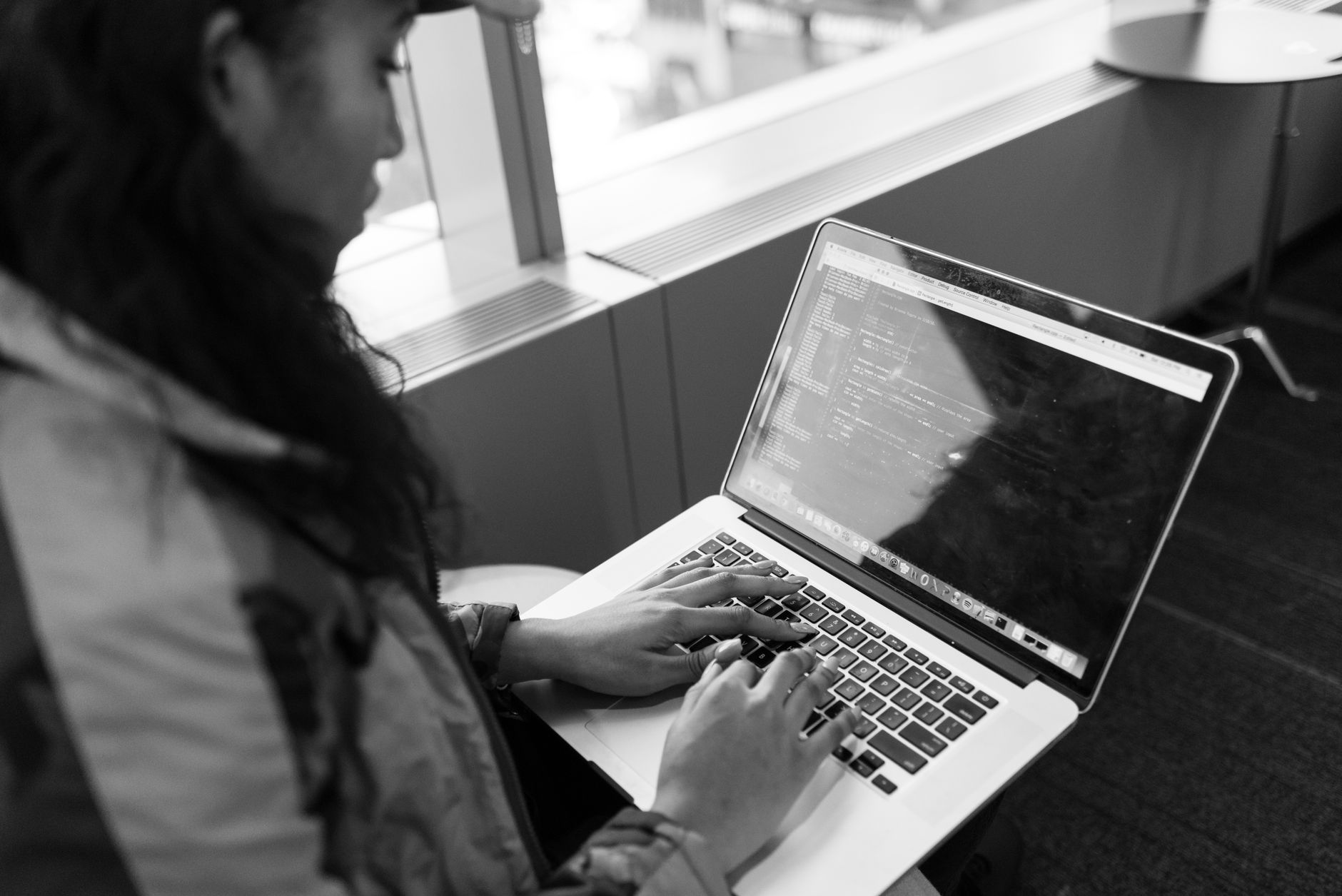 Developer reviewing GitHub issues on laptop