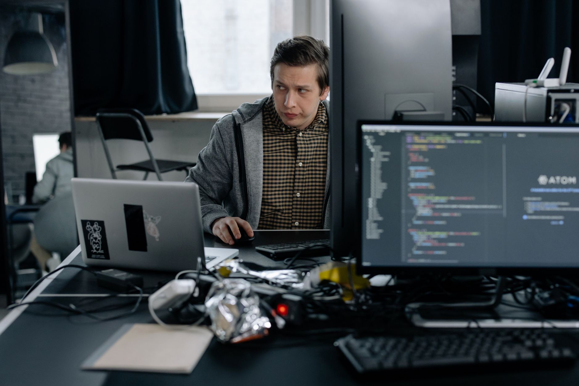Developer reviewing GitHub issues on a laptop, integrated into Foco