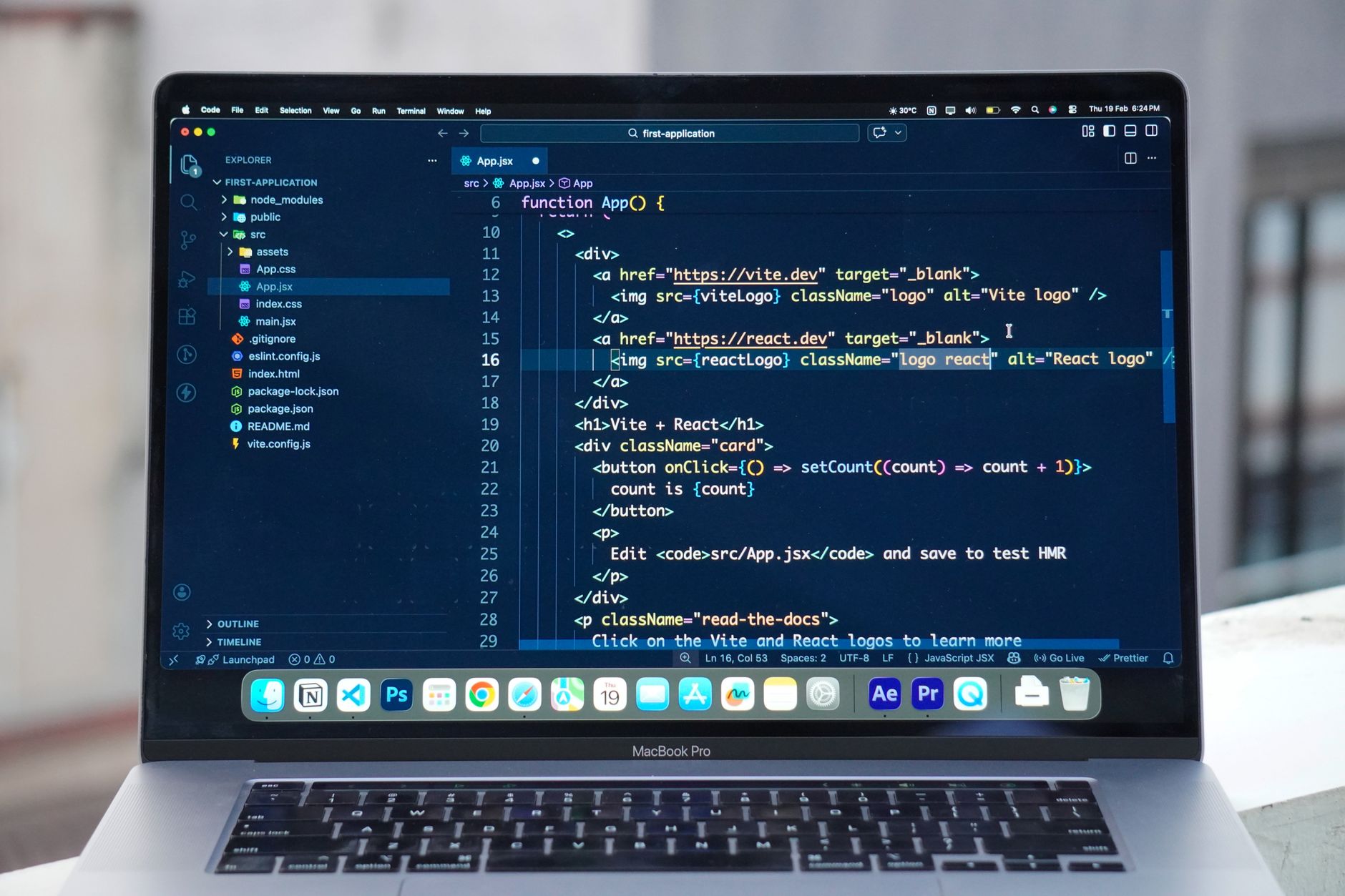Developer comparing Foco and Trello on their laptop, with notes on paper.