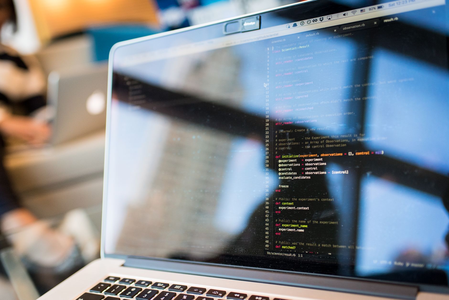 Developer reviewing GitHub and Jira tasks on a laptop with Foco Plus