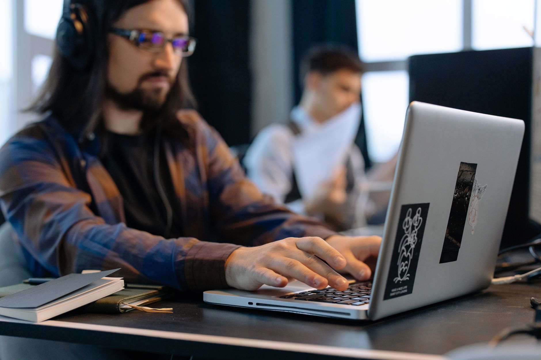 Developer reviewing GitHub and Jira tasks on a unified dashboard on laptop