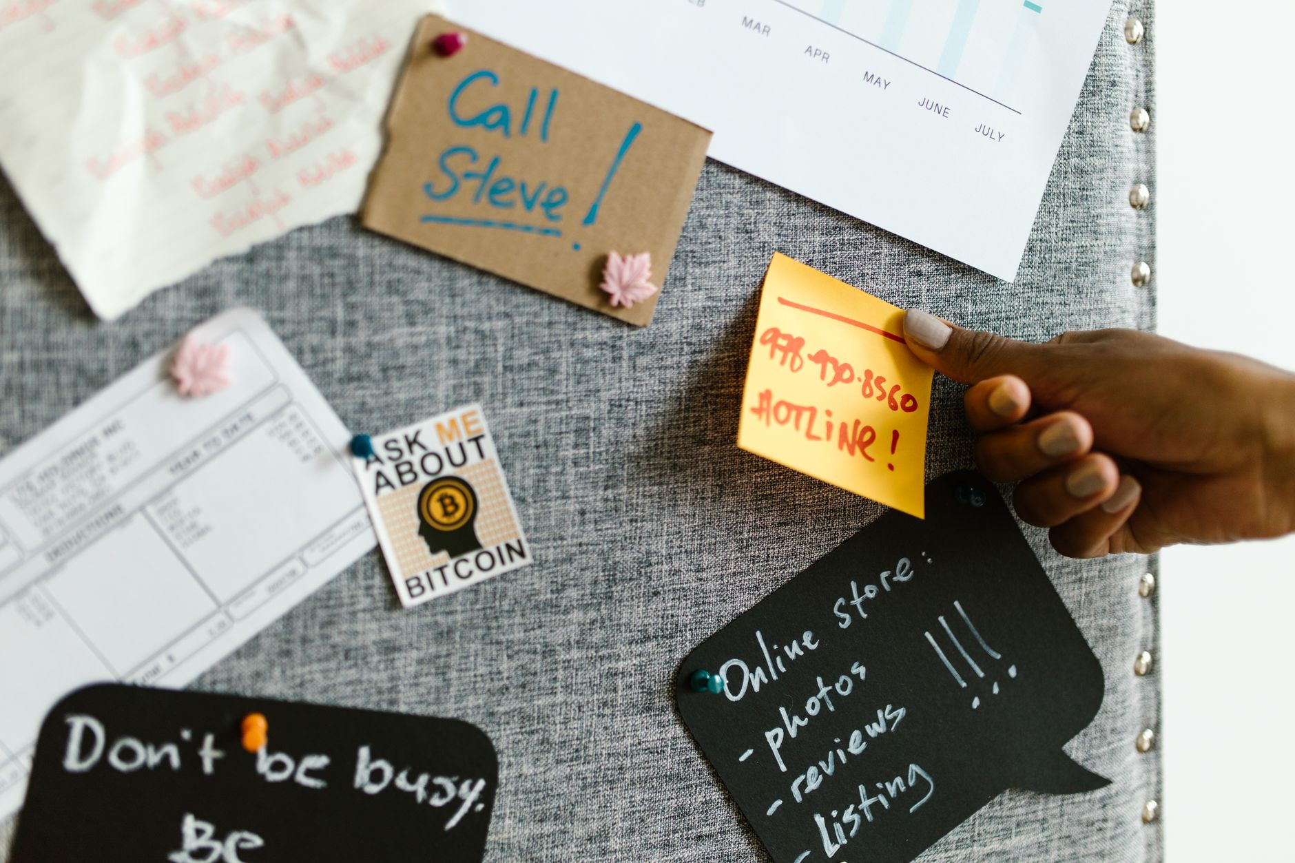 Freelancer organizing tasks on a Kanban board with color-coded sticky notes.