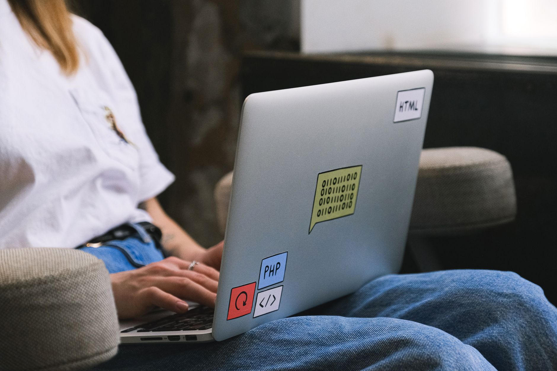 Developer reviewing GitHub, Jira, and Asana tabs on a laptop