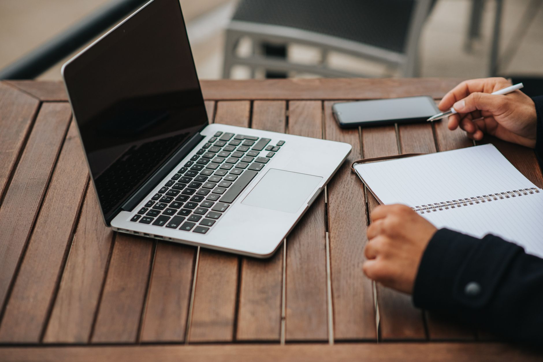 Freelancer planning three daily tasks in a notebook