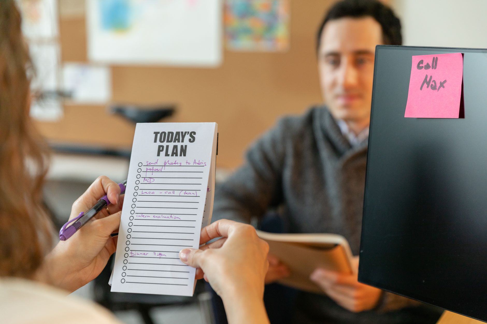 Team prioritizing tasks on a whiteboard with the three-task rule