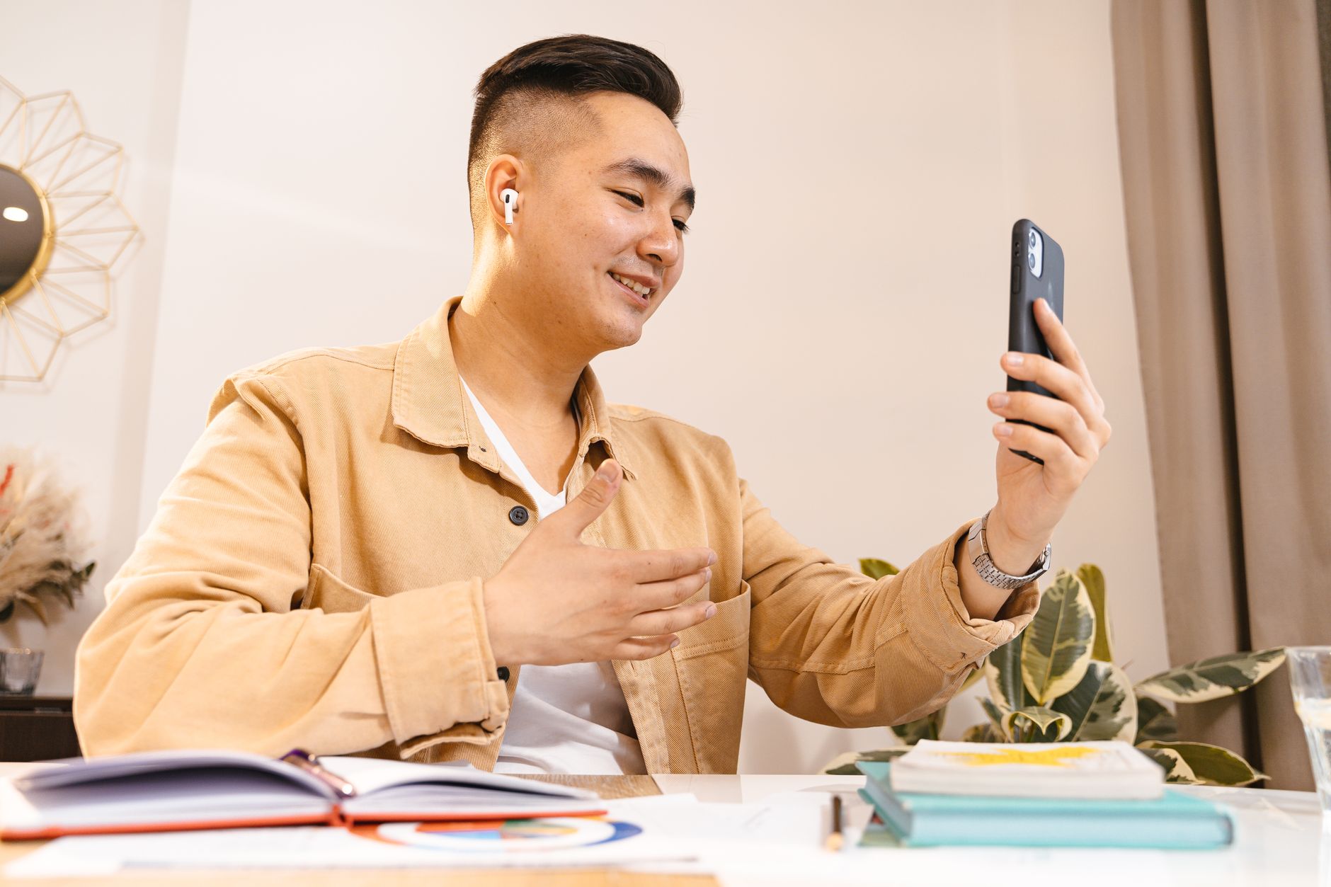Remote worker checking their microtasks list on phone during a video call