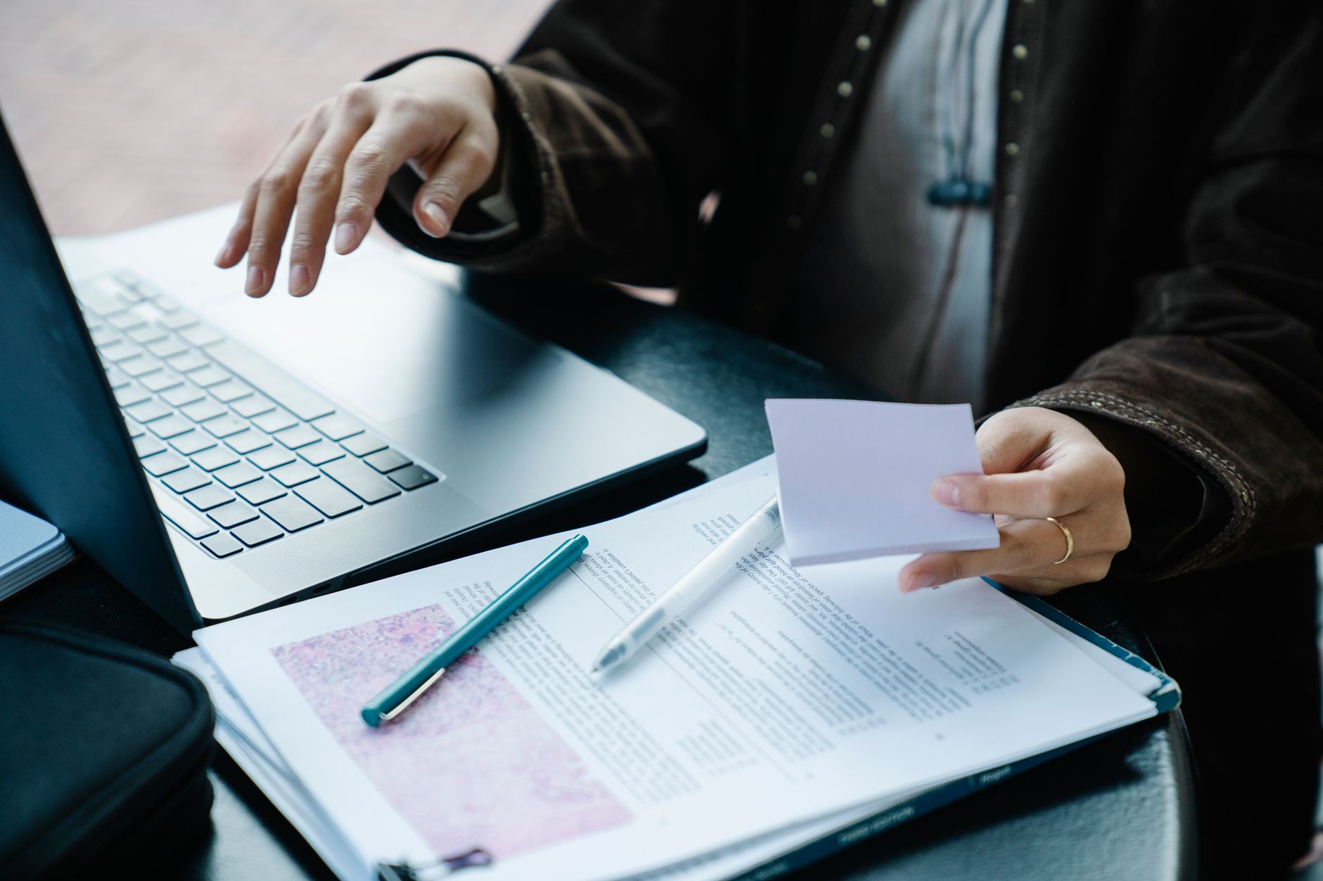 Freelancer organizing tasks for multiple clients on a laptop