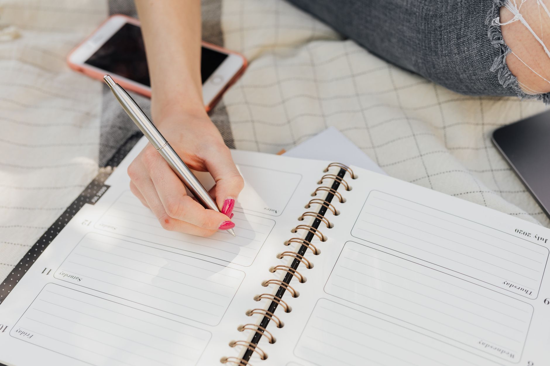 Person planning their week using the Zen To Done method in a notebook